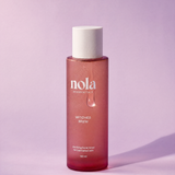 Witches Brew clarifying toner bottle by Nola Skinsentials with water droplets.