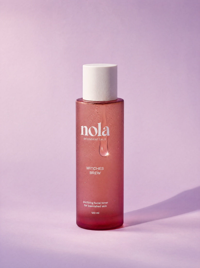Witches Brew clarifying toner bottle by Nola Skinsentials with water droplets.