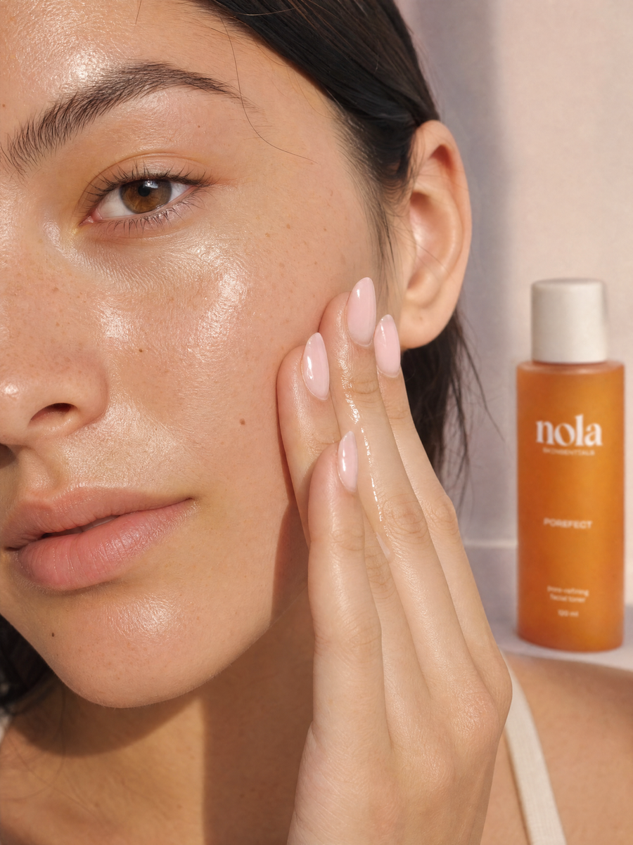 Woman applying Porefect toner with her hands, with the bottle in the background.