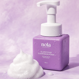 Clarifying Cleansing Foam bottle by Nola Skinsentials with foamy lather.