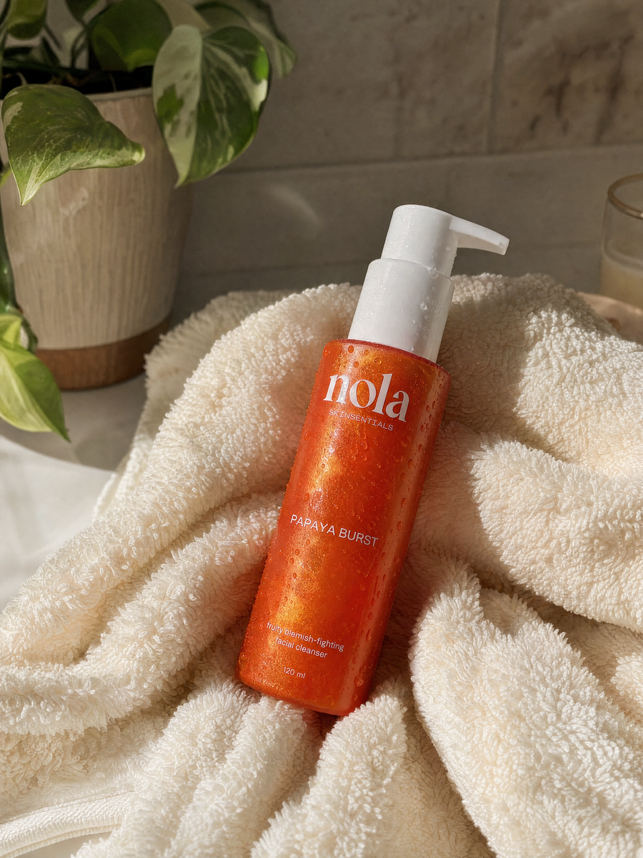 Papaya Burst cleanser on a bathroom counter as part of a daily skincare routine.