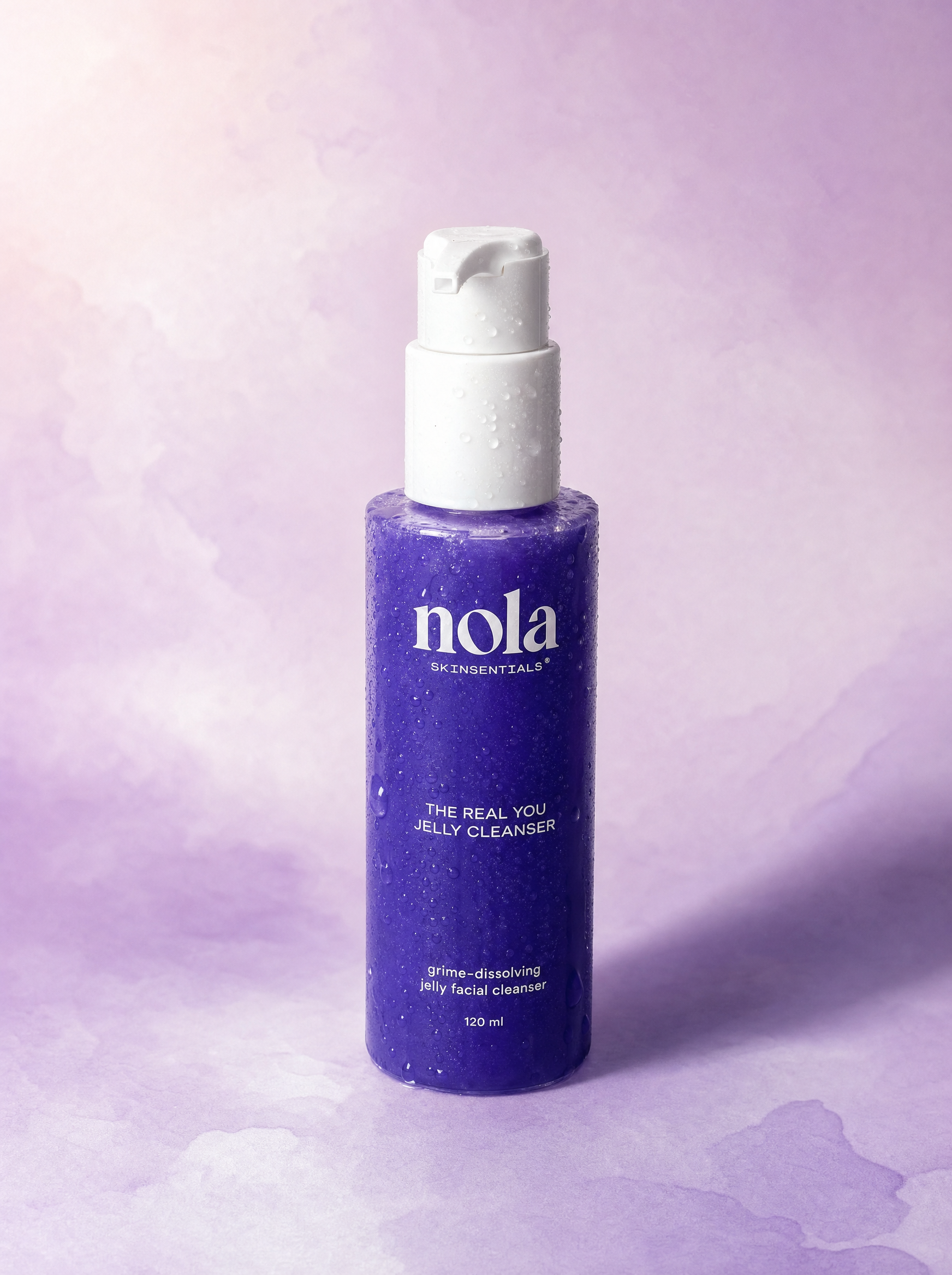 The Real You Jelly Cleanser bottle by Nola Skinsentials on a soft lavender background.