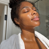Woman showing soft, glowing skin after using the jelly cleanser.
