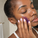 Woman applying The Real You Jelly Cleanser to her face during her routine.