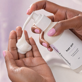 Hand dispensing creamy Baby Skin cleanser from the pump bottle.