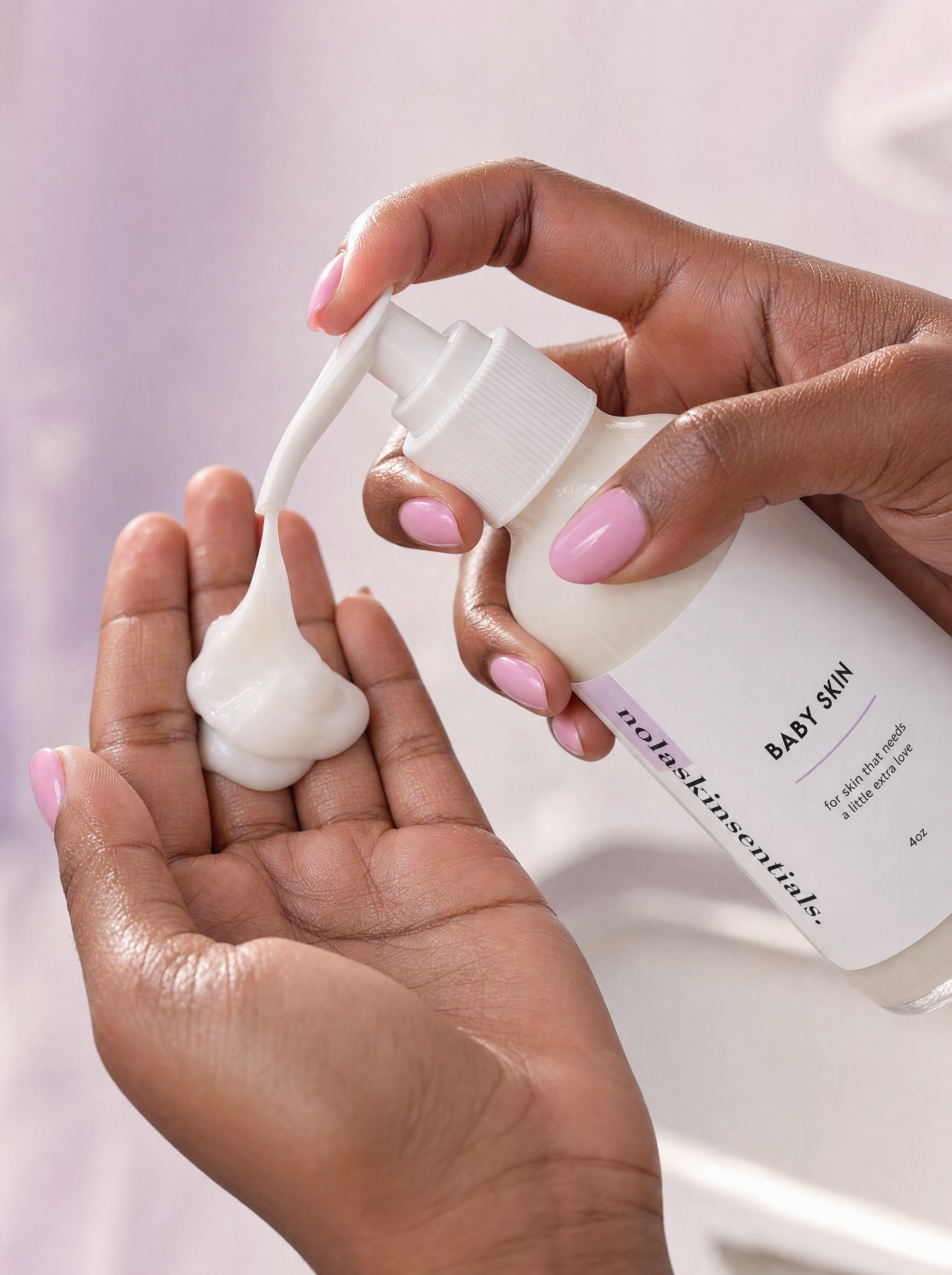 Hand dispensing creamy Baby Skin cleanser from the pump bottle.