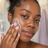 Woman massaging Baby Skin ceramide face wash onto her face.