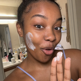 Woman using Baby Skin cleanser in a candid skincare moment.