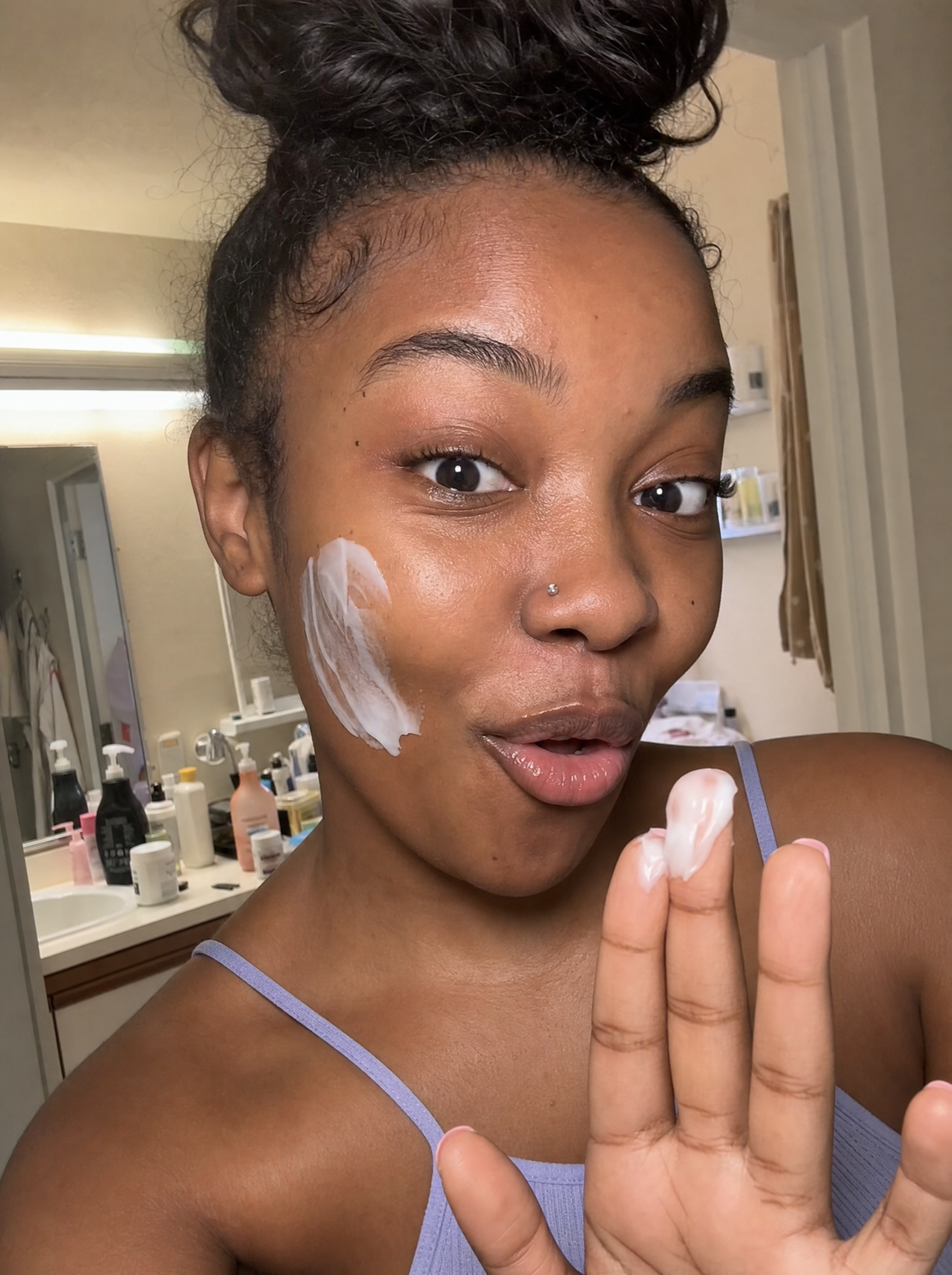 Woman using Baby Skin cleanser in a candid skincare moment.