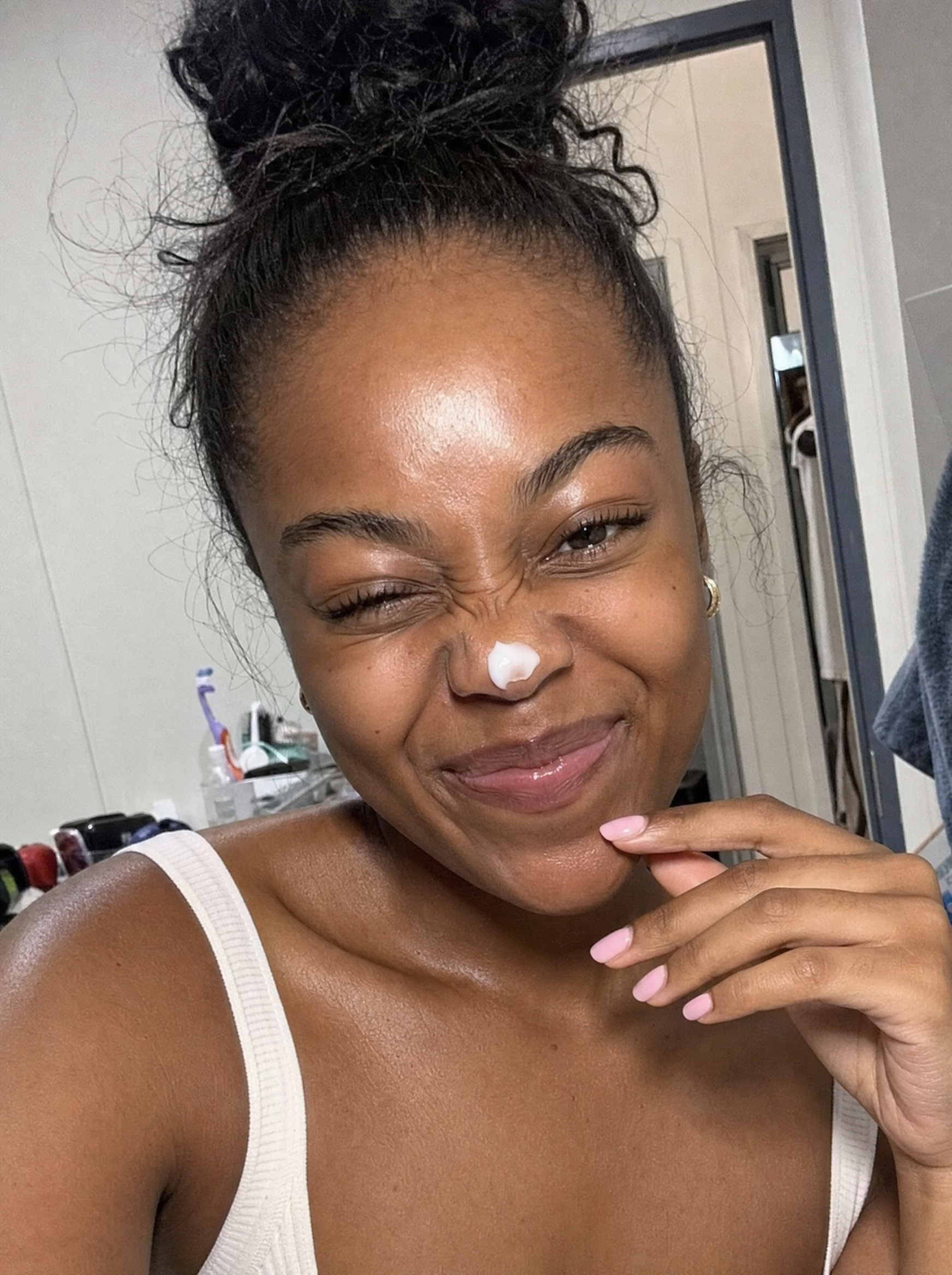 Woman smiling with Baby Skin face wash during her routine.