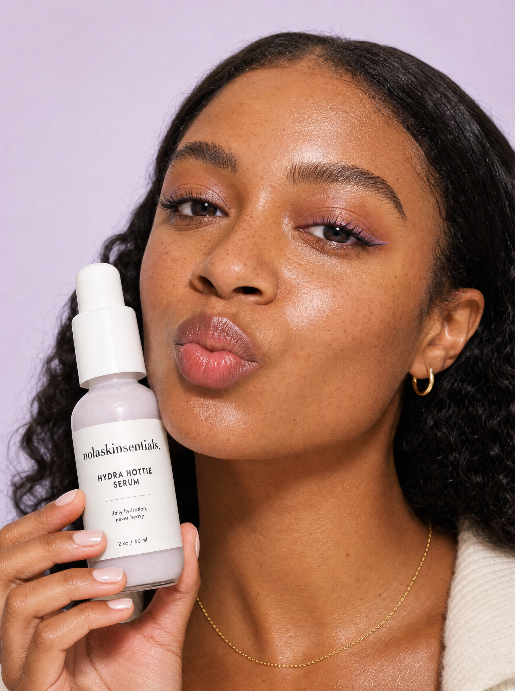 Hydra Hottie Serum by NOLA Skinsentials with close-up of naturally radiant hydrated skin